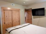 Flat screen TV and closet in the Guest bedroom
